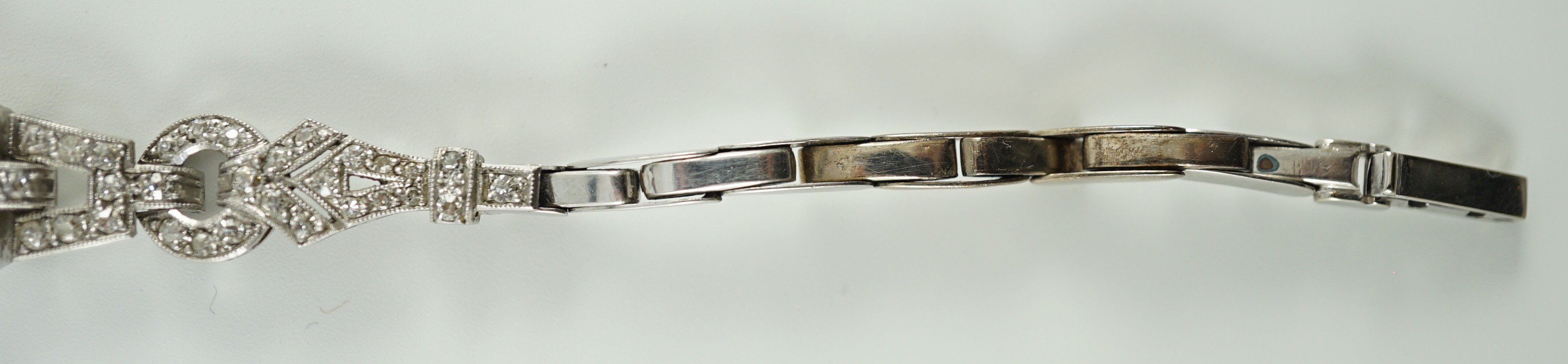 A lady's 1920’s platinum and round brilliant cut diamond set manual wind cocktail watch, on a white gold expanding bracelet